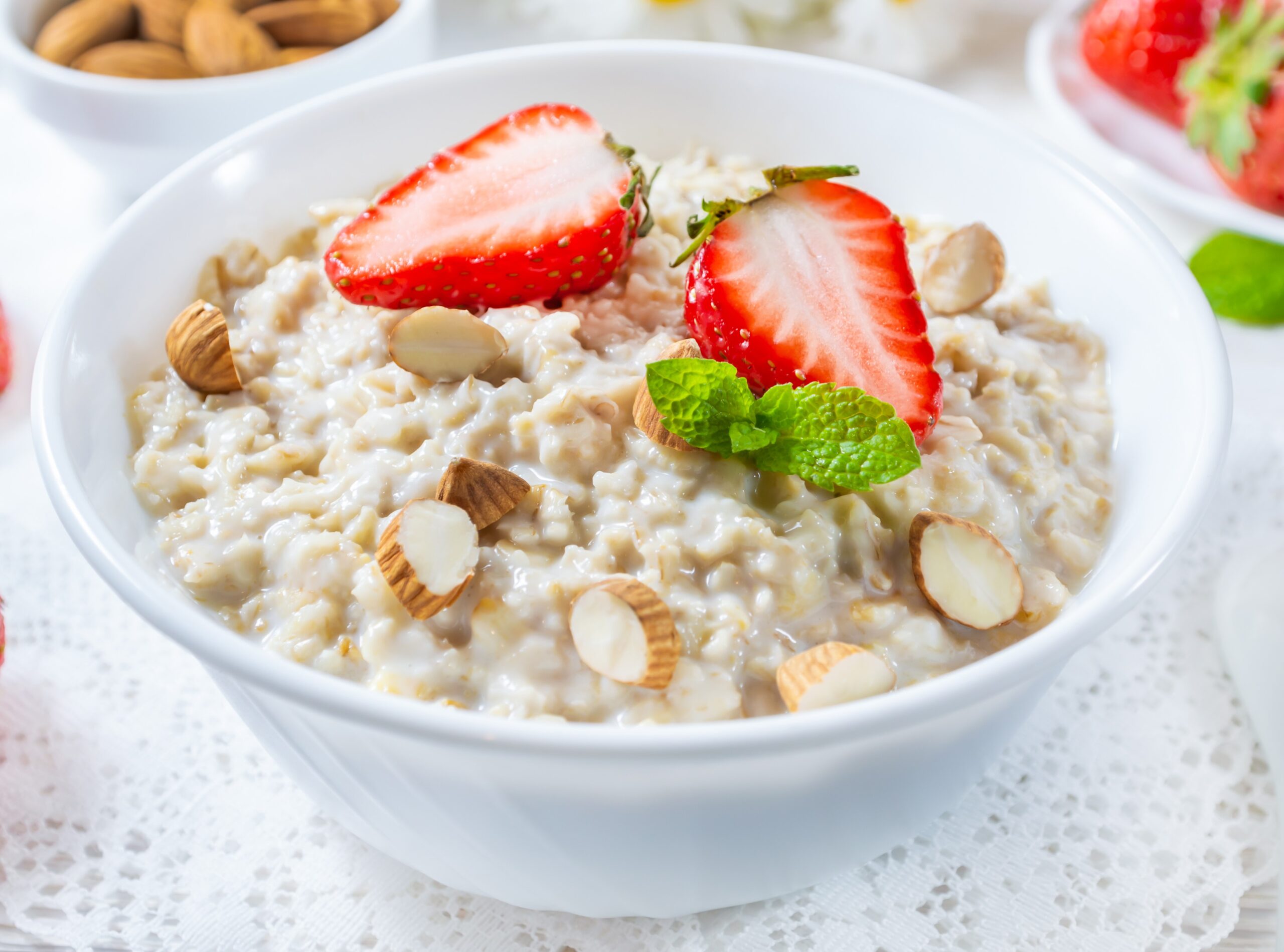 oatmeal with strawberry nuts bowl white wooden table scaled